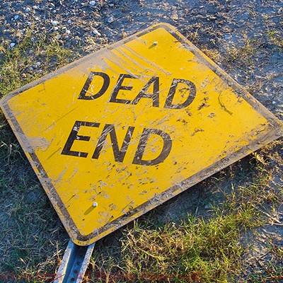 Dead End street sign lying on the ground